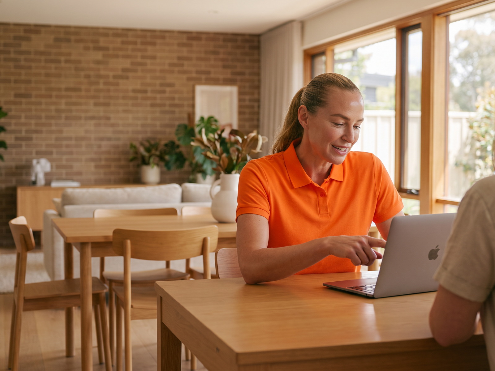 Apple Mac Support 1 Technician working on a MacBook at a customer's dining table